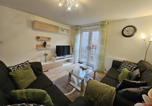 a living room with a couch and a tv at Cosy & Stylish One-Bed Flat-close to Warwick Uni in Coventry