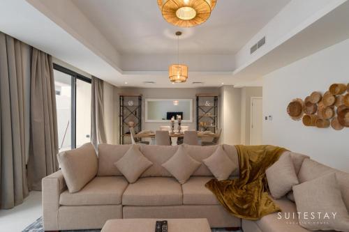 a living room with a couch and a table at Boho Inspired Large Luxury Villa in Dubai