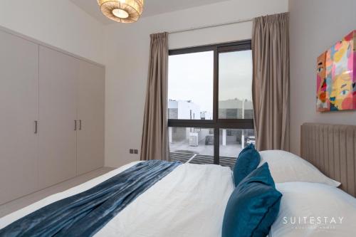 a bedroom with a bed and a large window at Boho Inspired Large Luxury Villa in Dubai