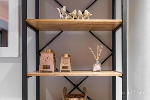a shelf with three candles and baskets on it at Boho Inspired Large Luxury Villa in Dubai