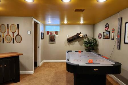 a room with a table in the middle of a room at Large Cozy House Near NexusPark Air Hockey in Columbus