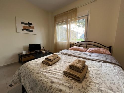 a bedroom with a bed with two towels on it at Cozy Corner in Alexandroupoli
