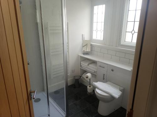 a white bathroom with a toilet and a shower at Hull City Centre Accommodation 1 in Hull