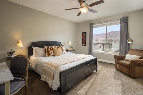 a bedroom with a bed with a ceiling fan and a window at Entrada at Moab 635 in Moab