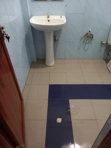 a bathroom with a sink and a toilet and a white sink at new blue lotus in Mirissa