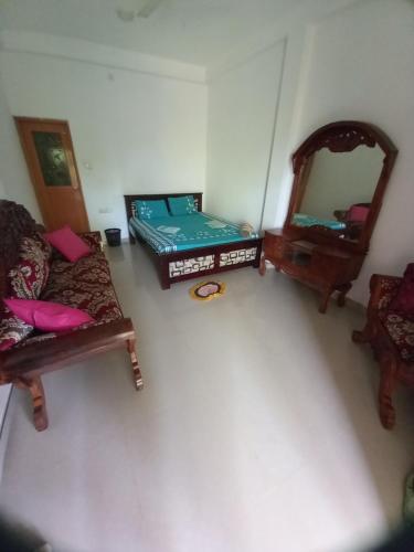 a room with two beds and a mirror at new blue lotus in Mirissa