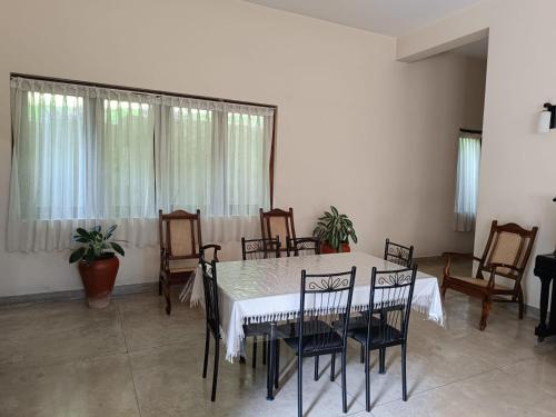 a dining room with a table and chairs at Shalom in Peradeniya
