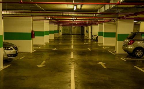 a parking garage with two cars parked in it at Apartment Unamare in Belgrade