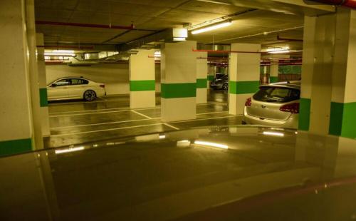 a parking garage with two cars parked in it at Apartment Unamare in Belgrade