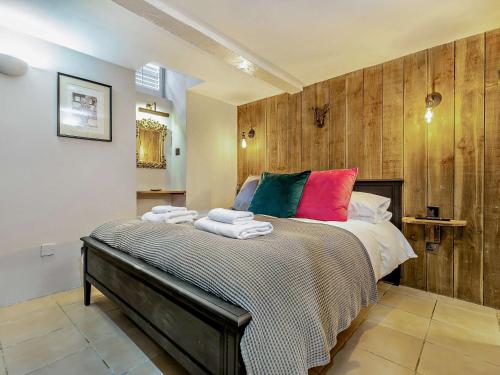 a bedroom with a large bed with colorful pillows at 1 bed property in St Ives 85786 in St Ives