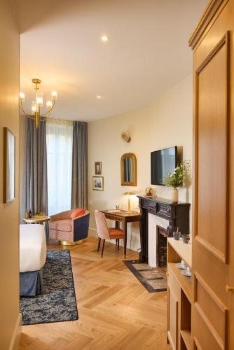 a hotel room with a bed and a desk at Maison 1896 in Beaune