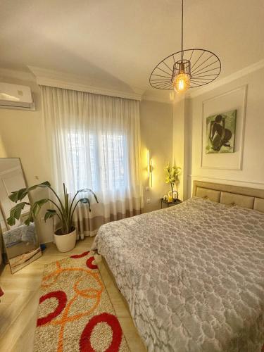 a bedroom with a large bed and a window at Psimithefto Luxury Apartments in Thessaloniki