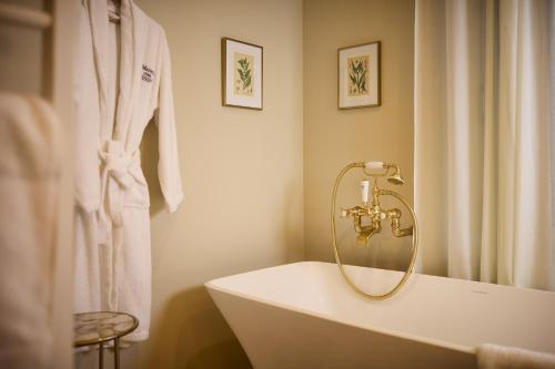 a white bath tub in a bathroom with a shower at Maison 1896 in Beaune