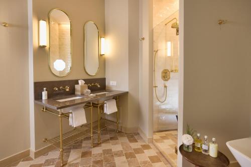 a bathroom with a sink and a mirror at Maison 1896 in Beaune