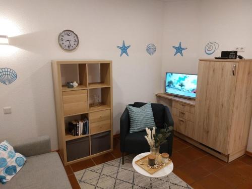 ein Wohnzimmer mit einem Stuhl und Sternen an der Wand in der Unterkunft Haus Rika 2 in Neuharlingersiel