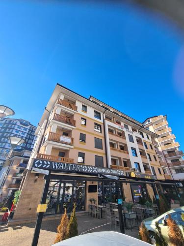 a building with a sign on the front of it at Apartman Vip Aleksa Zlatibor Centar in Zlatibor
