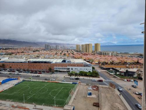 an aerial view of a soccer field in a city at El Faro Antofagasta in Antofagasta