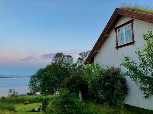 a house with a window on the side of it at House by the Sea in Sortland