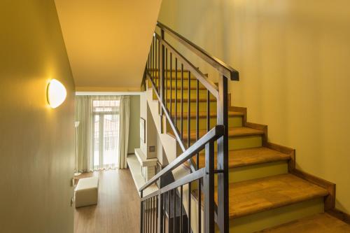 a staircase in a home with wooden floors and a window at Ruskovets Thermal SPA & Ski Resort in Bansko