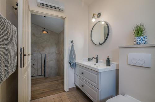 a bathroom with a sink and a mirror at Villa Linna with seaview in Pinezici