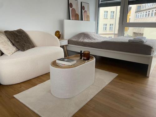 a living room with a couch and a bed at Studio Apartment mit Stellplatz in Bielefeld