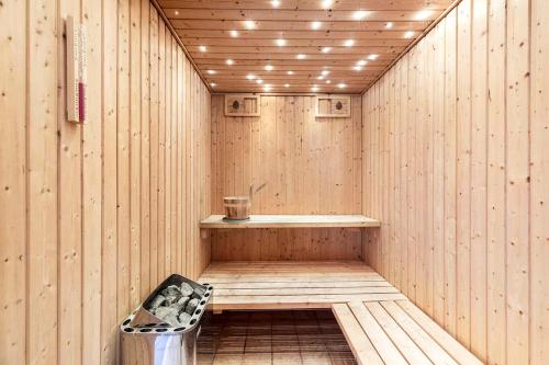 a wooden sauna with a bench in the middle at Large Cottage In Peaceful, Beautiful Nature in Mølby