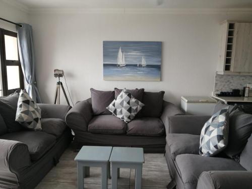 a living room with a couch and a table at Summer Place 36 in Margate