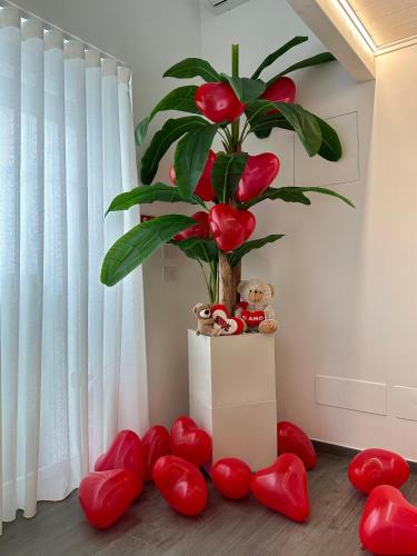 a plant in a room with red hearts around it at B&B Butterfly Suite in Bitritto
