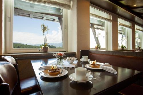a dining room with a table with two plates of food at AllgäuStern Hotel in Sonthofen