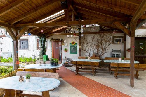 an outdoor patio with tables and chairs and a table and chairs at Kräuterhotel Garni Zur Klostergrotte in Nohra
