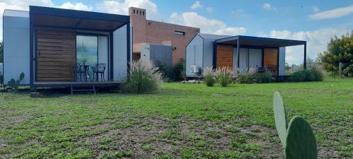 a small home with a building in a field at Cantal Tiny house in Salta