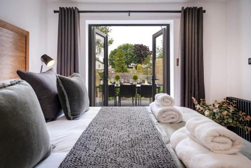 a room with a bed with towels on it at Berkeley House in Windermere