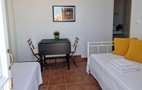 a room with two beds and a table with a desk at Panoramic View apartment in Poros