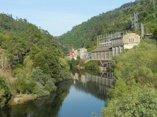 a river with buildings on the side of a mountain at Casa Dos Cabecinhos in Paradamonte