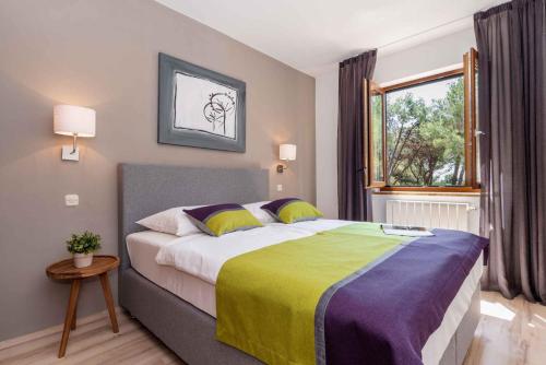 a bedroom with a large bed and a window at Apartment Rabac 28 in Rabac