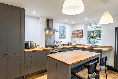 a kitchen with a wooden counter top and a sink at Stylish Battersea Home in London