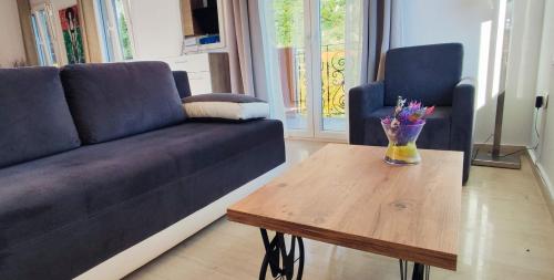a living room with a couch and a wooden table at Villa Amaryllis in Paleokastritsa