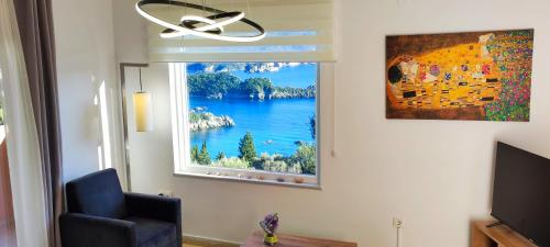 a window in a room with a view of a lake at Villa Amaryllis in Paleokastritsa