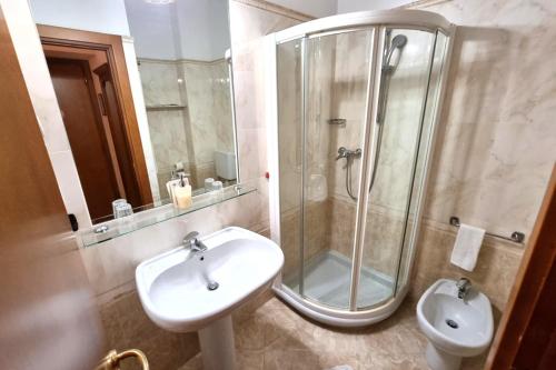 a bathroom with a sink and a shower and a toilet at Hotel Acqui & Centro Benessere in Acqui Terme