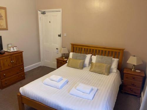 a bedroom with a bed with two towels on it at The Westminster Hotel in Buxton