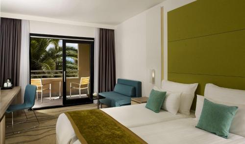 a hotel room with a bed and a balcony at Park Plaza Histria Pula in Pula