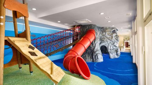 a childrens room with a red inflatable slide at Park Plaza Verudela Pula in Pula