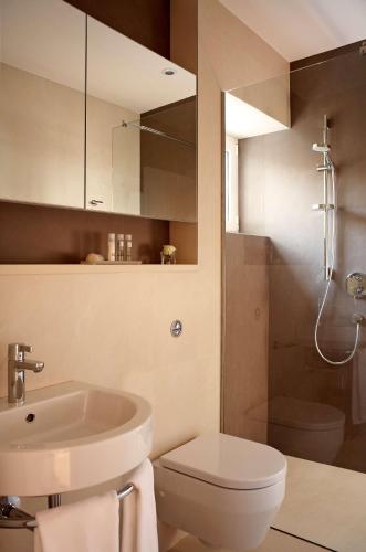 a bathroom with a sink and a toilet and a shower at Park Plaza Verudela Pula in Pula