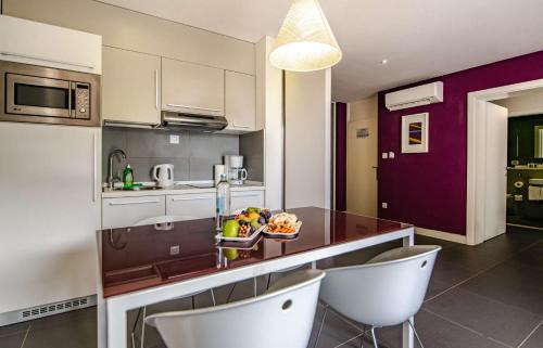 a kitchen with a counter with a bowl of fruit on it at Park Plaza Verudela Pula in Pula