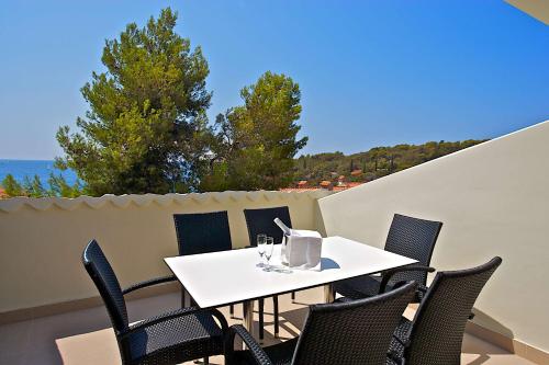 a white table and chairs on a balcony at Park Plaza Verudela Pula in Pula