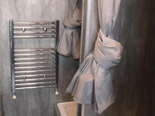 a group of towels hanging on a rack in a bathroom at The Anfield View in Liverpool