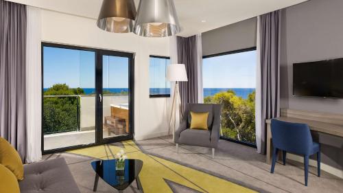 a living room with a view of the ocean at Park Plaza Arena Pula in Pula