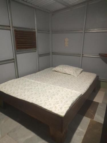 a bedroom with a bed in a room at Chava Camping Rio Celeste in Rio Celeste