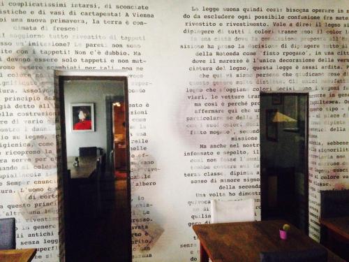 a wall with writing on it in a room at La Bussola Da Gino in Quarrata