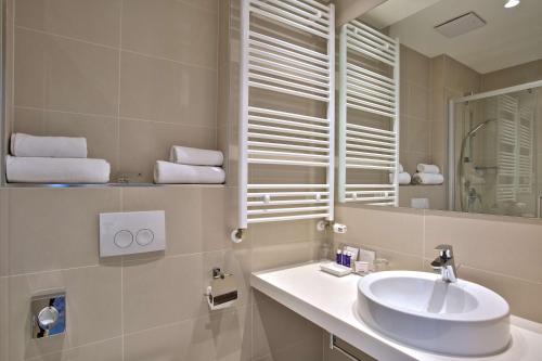 a bathroom with a sink and a mirror at Park Plaza Belvedere Medulin in Medulin